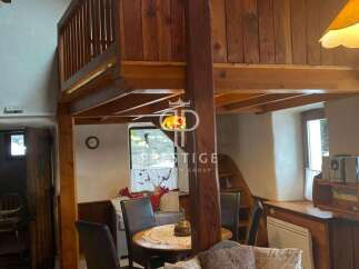 Discover the charm of this unique property, featuring a cozy interior with wooden accents and a loft area.