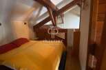 Discover a charming bedroom with exposed wooden beams, creating a cozy and rustic atmosphere.