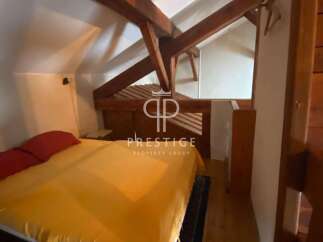Discover a charming bedroom with exposed wooden beams, creating a cozy and rustic atmosphere.