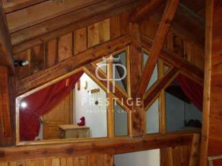 Discover the charm of this unique property, featuring stunning wooden architecture and a cozy, inviting atmosphere.