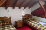 Charming bedroom with rustic wooden beams and cozy twin beds.