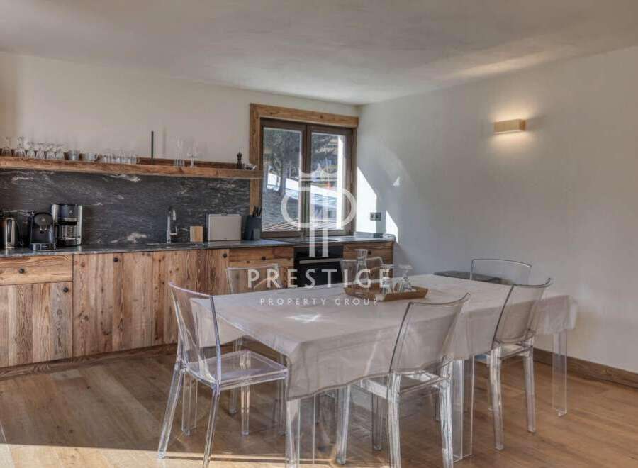 Discover a stunning property featuring a modern kitchen with wooden cabinets and a sleek countertop.