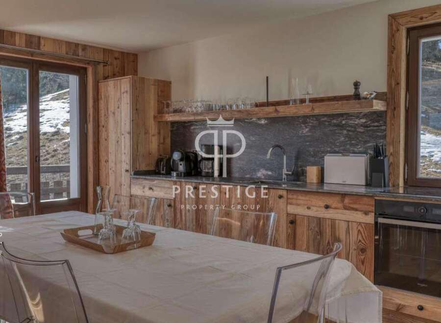 Discover the charm of this stunning property, featuring a beautifully designed kitchen with rustic wooden cabinetry and sleek countertops.