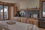 Discover the charm of this stunning property, featuring a beautifully designed kitchen with rustic wooden cabinetry and sleek countertops.