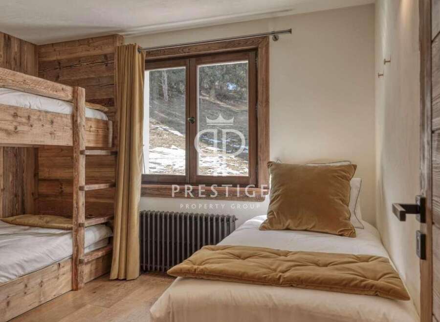 Cozy bedroom featuring a bunk bed and a single bed, perfect for accommodating guests.