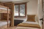 Cozy bedroom featuring a bunk bed and a single bed, perfect for accommodating guests.