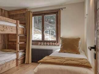 Cozy bedroom featuring a bunk bed and a single bed, perfect for accommodating guests.