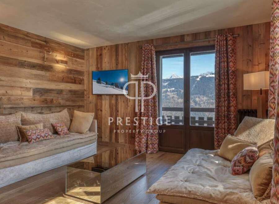 Experience luxury living in this stunning property, featuring a cozy living room with a beautiful wooden wall.