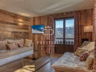 Experience luxury living in this stunning property, featuring a cozy living room with a beautiful wooden wall.