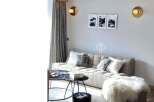 Discover a stylish living space with a modern sofa and elegant wall art.