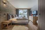 Experience luxury in this stunning bedroom with a cozy ambiance.