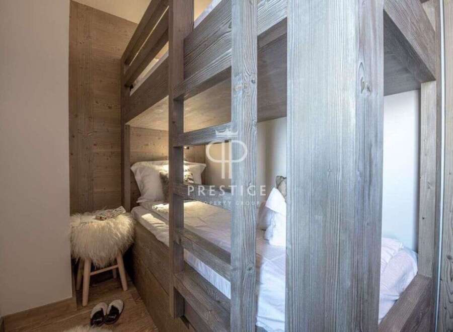Discover the charm of this cozy bedroom featuring a unique bunk bed design.