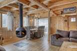 Experience the warmth of this stunning cabin with its inviting fireplace and rustic wooden interior.