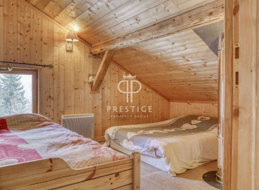 Discover the charm of this cozy bedroom with its warm wooden interior.