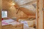 Discover the charm of this cozy bedroom with its warm wooden interior.
