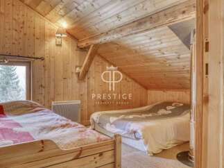 Discover the charm of this cozy bedroom with its warm wooden interior.