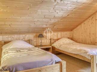 Discover the charm of this cozy bedroom, featuring rustic wooden accents that create a warm and inviting atmosphere.