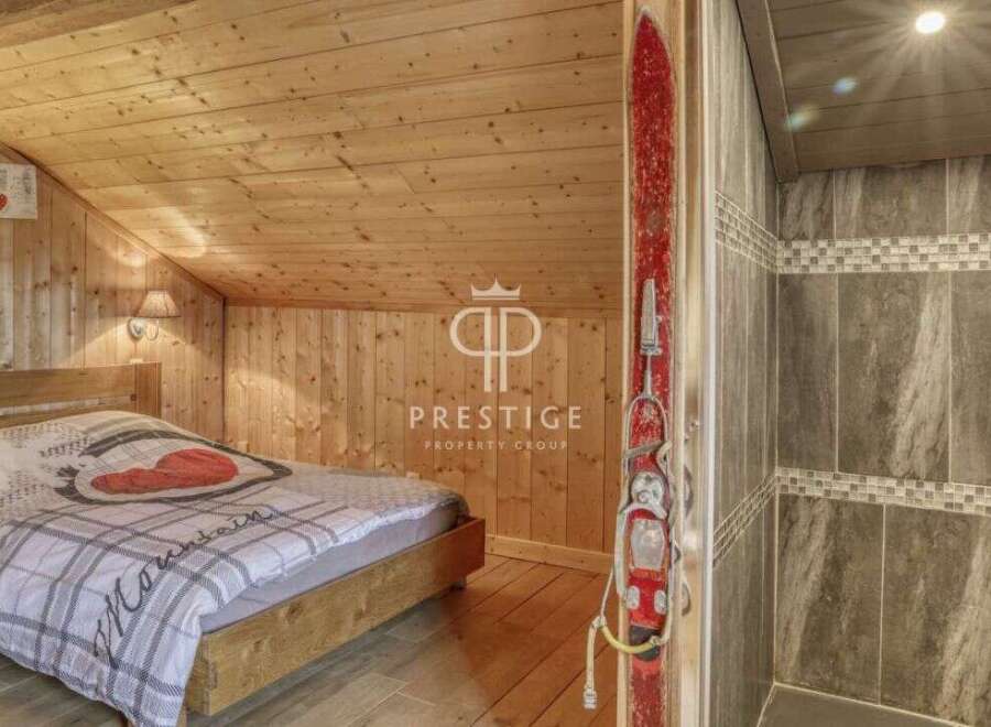 Discover the charm of this cozy mountain retreat! Featuring a rustic wooden interior, this property offers a warm and inviting atmosphere.