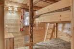 Discover the charm of this cozy cabin with its rustic wooden interior.