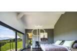Experience luxury living in this stunning bedroom with breathtaking views.