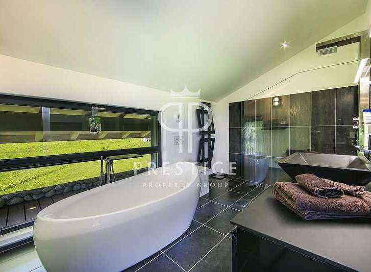 Indulge in luxury within this stunning bathroom, featuring a sleek, modern design.