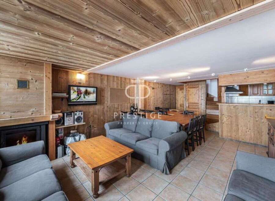 Experience rustic charm in this stunning property, featuring warm wooden interiors and a cozy fireplace.