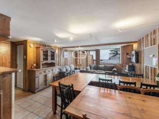 Discover the charm of this cozy property, featuring warm wooden interiors and a spacious dining area perfect for gatherings.