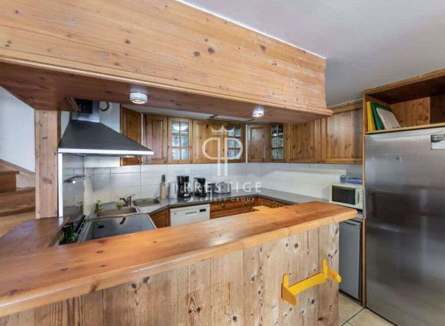 Discover the charm of this cozy kitchen, featuring warm wooden cabinetry and a functional layout.