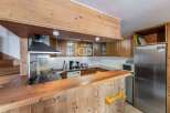 Discover the charm of this cozy kitchen, featuring warm wooden cabinetry and a functional layout.