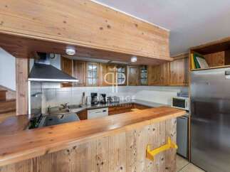 Discover the charm of this cozy kitchen, featuring warm wooden cabinetry and a functional layout.