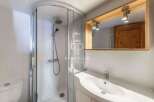 Discover a modern bathroom with a sleek shower enclosure and a stylish vanity.