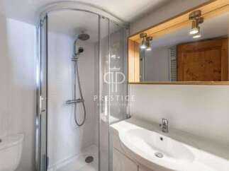 Discover a modern bathroom with a sleek shower enclosure and a stylish vanity.