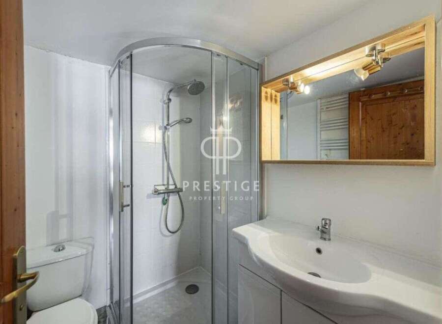Discover a modern bathroom with a sleek shower enclosure and a stylish vanity.
