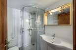 Discover a modern bathroom with a sleek shower enclosure and a stylish vanity.