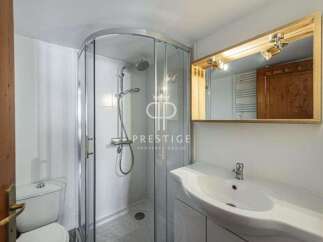 Discover a modern bathroom with a sleek shower enclosure and a stylish vanity.