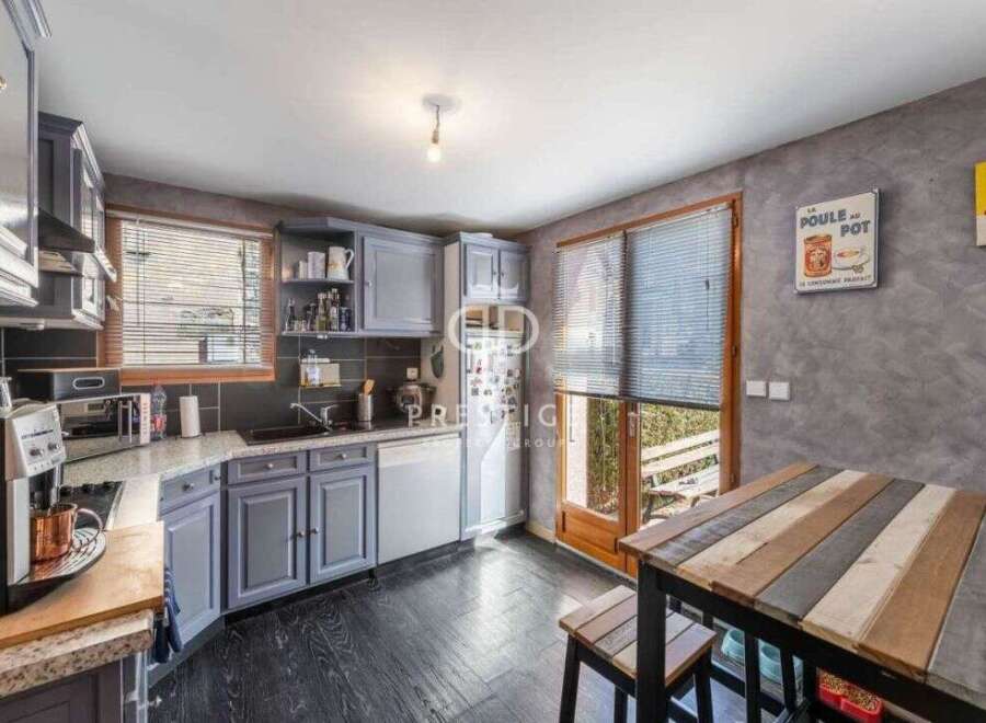 Discover this charming kitchen with its stylish gray cabinetry and sleek black countertops.