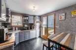 Discover this charming kitchen with its stylish gray cabinetry and sleek black countertops.