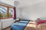 Cozy bedroom with stunning mountain views.
