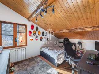 Discover a cozy attic bedroom with a unique design.