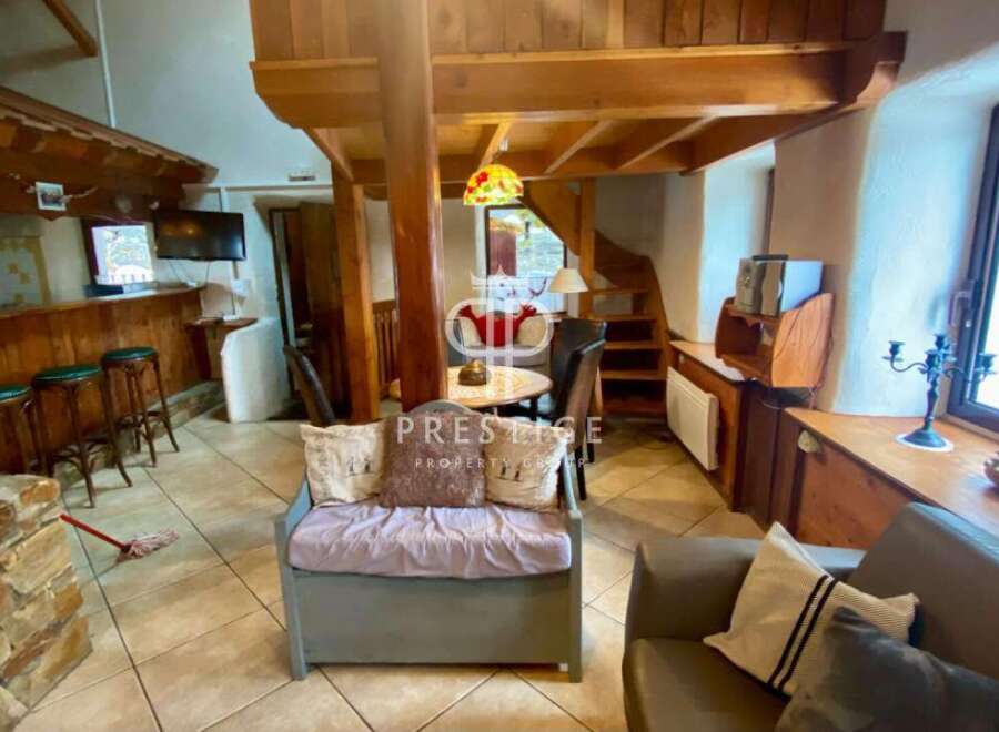 Discover the charm of this unique property, featuring a cozy interior with exposed wooden beams and a rustic aesthetic.