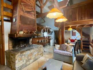 Discover the charm of this stunning property, featuring a cozy fireplace and exposed wooden beams that exude warmth and character.
