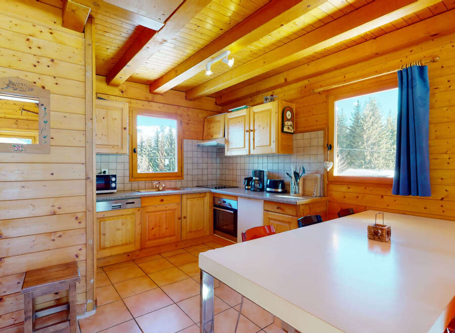 Step into this charming cabin kitchen, featuring warm wooden accents and a cozy atmosphere.