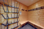 This cozy ski room features wooden walls and benches, perfect for storing and organizing your gear.