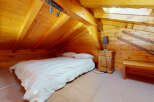 Cozy cabin bedroom with a rustic wooden interior.