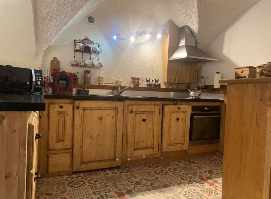 Rustic charm meets modern convenience in this charming kitchen.