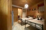Cozy chalet bedroom with twin beds, perfect for a family getaway.