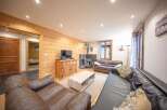 Discover the charm of this cozy living space, featuring warm wooden accents and a welcoming atmosphere.
