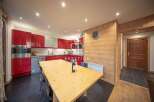 Discover this stunning property featuring a modern kitchen with sleek red cabinetry and stainless steel appliances.