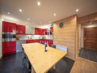Discover this stunning property featuring a modern kitchen with sleek red cabinetry and stainless steel appliances.