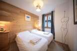 This cozy bedroom features two comfortable twin beds, perfect for a relaxing stay.